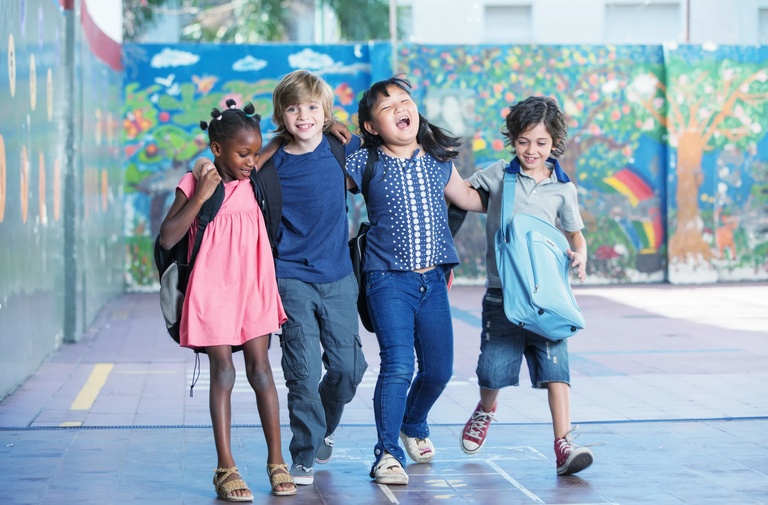 Group of school-age children laughing and walking together