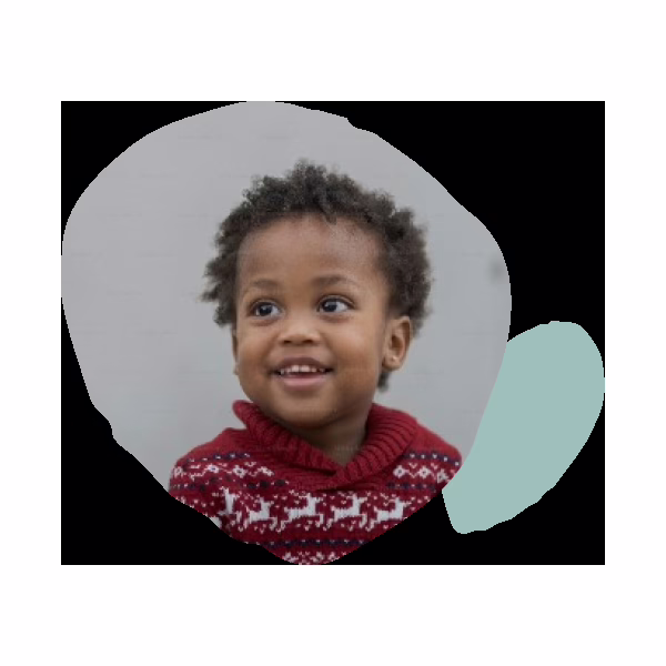 A smiling child wearing a red sweater