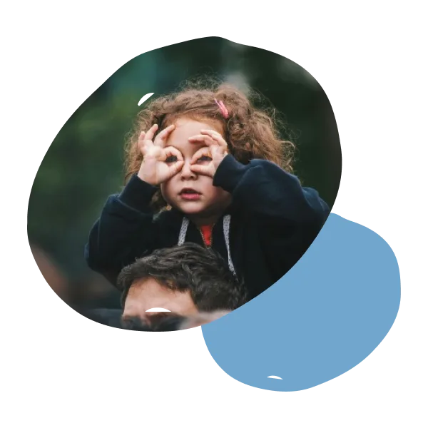 A child peering through her fingers